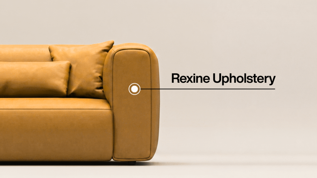 Close-up of a tan rexine-upholstered sofa with the label "Rexine Upholstery" pointing to the armrest.