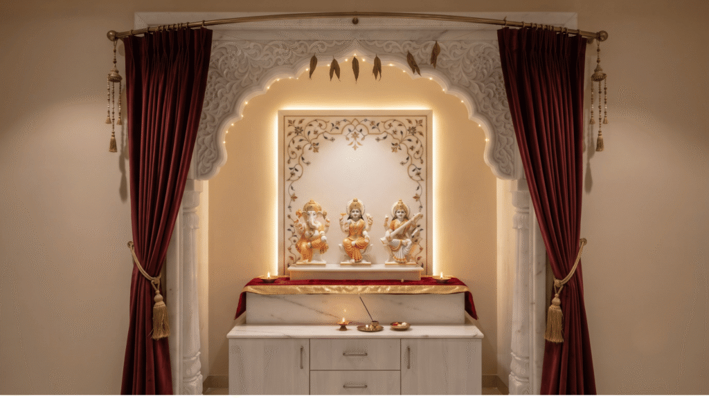 Home mandir shrine styled for Diwali, featuring a carved marble archway and backdrop framed by rich maroon drapes with gold tiebacks, illuminated by warm backlighting and hanging fairy lights, with lit diyas and divine statues arranged on the altar.