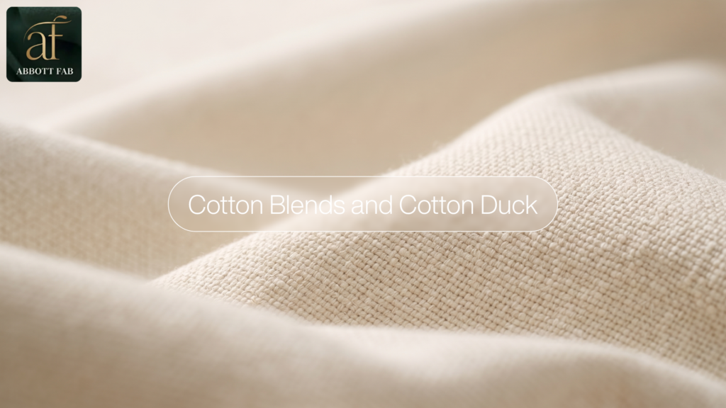 ABBOTT FAB product showcase image featuring the Abbott Fab brand logo, a centered badge reading Cotton Blends and Cotton Duck, and a close-up photograph of off-white cotton fabric in soft, durable woven folds