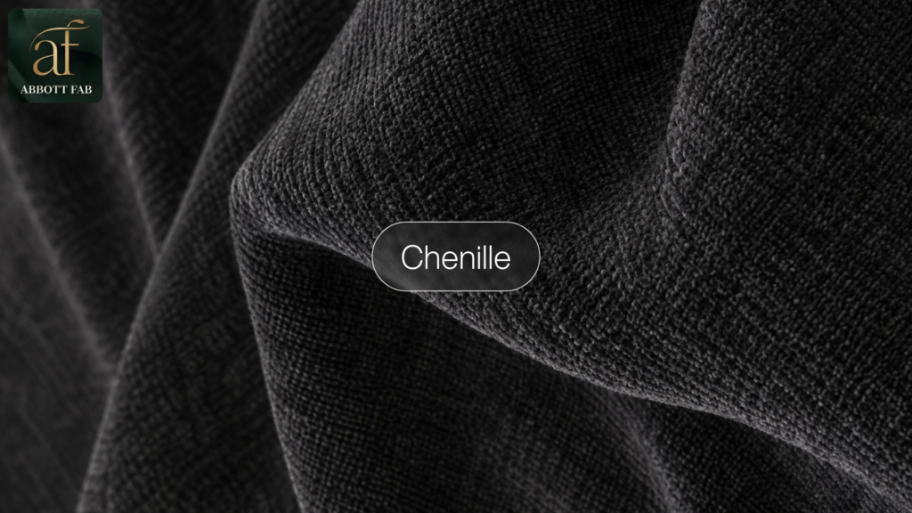 ABBOTT FAB product showcase image featuring the Abbott Fab brand logo, a centered badge reading Chenille, and a close-up photograph of dark grey chenille fabric in soft, textured folds.