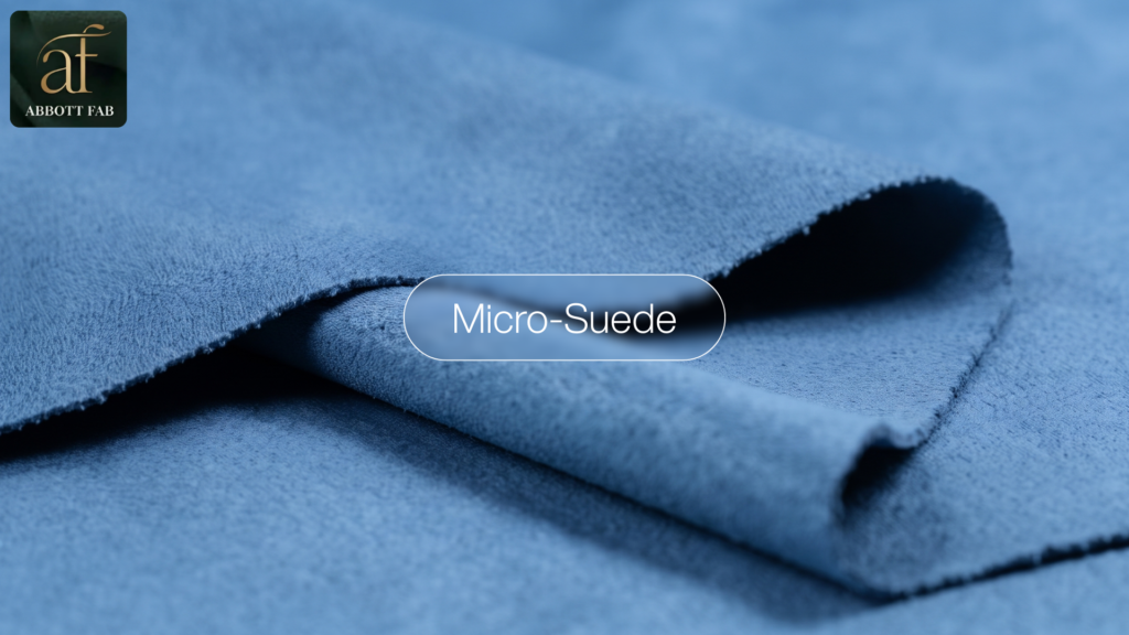 ABBOTT FAB product showcase image featuring the Abbott Fab brand logo, a centered badge reading Micro-Suede, and a close-up photograph of soft blue micro-suede fabric in smooth draped folds.